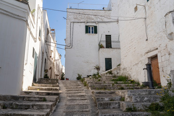 Fototapeta na wymiar OSTUNI, ITALY - April 30, 2019: touristic trip. Travel view of Ostuni featuring some white houses part of the center of the village, historical center. The image location is Apulia in Italy, Europe.