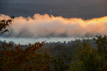 Fototapeta premium View of the fog covered valley below. Taken from the top of Morrow Mountain State Part NC