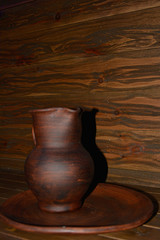 Clay jug in wood tone and wood texture background