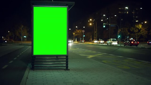 Bus stop advertising billboard green screen at night