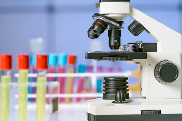 Microscope and test tubes  on laboratoy table