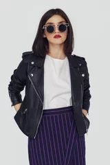 Fashion portrait of a young woman in leather jacket. © Natalia Chircova