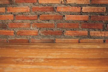 Wooden table in front Brick wall background