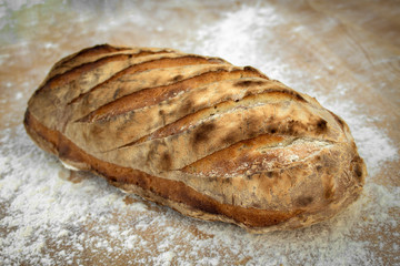 Closeup of freshly baked homemade bread on a wooden board.