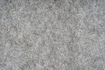 Grey heather knitted fabric made of synthetic fibres textured background. Grey knitted fabric texture. Background with delicate striped pattern