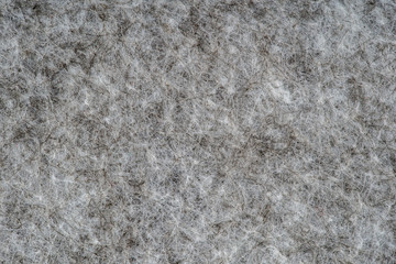 Grey heather knitted fabric made of synthetic fibres textured background. Grey knitted fabric texture. Background with delicate striped pattern