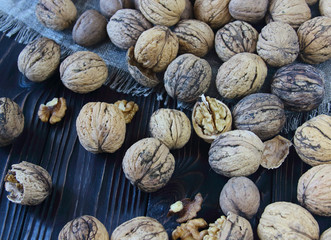 Walnuts on a rustic table, heap of walnut kernels, walnut background