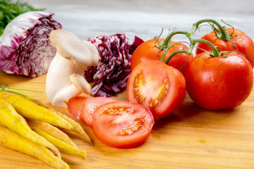 Tomatoes, mushrooms and cabbage on a cutting board readymade salad