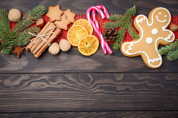 Christmas background with Cones, Gingerbread Cookies, Nuts, Spices and Dried oranges. Top view, flat lay, copy space.