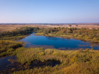 Aerial landscape of a lake in the forest at summer