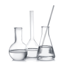 Laboratory glassware with liquid samples on white background