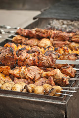 Barbecue fries in the coals. Meat and beef at the field kitchen festival.