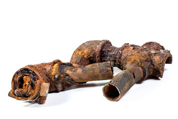 Fragments of old cast-iron water pipes on white background. After many years of operation corroded...