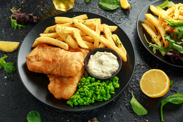 British Traditional Fish and chips with mashed peas, tartar sauce and cold beer.