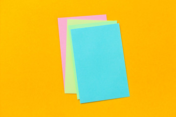 stack of colored stickers on a vivid yellow background