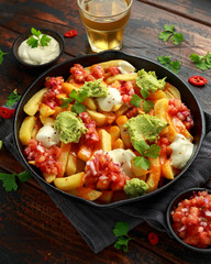 Loaded potato nachos with melted cheddar cheese, sour cream, tomato salsa, chilli, guacamole and beer