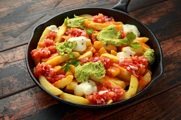 Loaded potato nachos with melted cheddar cheese, sour cream, tomato salsa, chilli, guacamole and beer