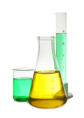 Laboratory glassware with colorful liquids on white background