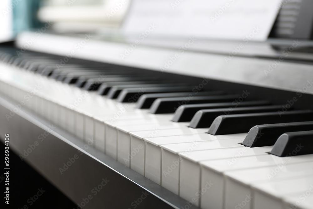 Poster Modern piano with music sheets in room, closeup