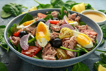 Protein packed tuna and soft, runny egg salad with pear shaped cherry tomatoes, black olives and...