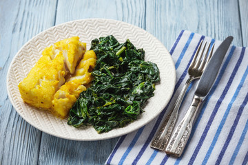 Pan-fried cod fillet, served with spinach.
