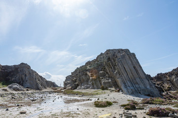 Rock formation in Newquay with clouds