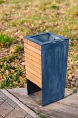 Close up of recycled wooden trash bin in the public park.