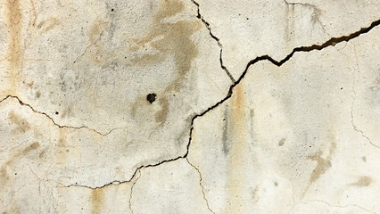 A crack on the concrete wall surface of a house in Los Angeles. Background image for design