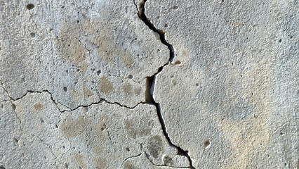  A crack on the concrete wall surface of a house in Los Angeles. Background image for design