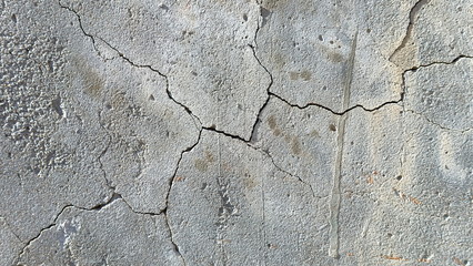 Fototapeta premium A crack on the concrete wall surface of a house in Los Angeles. Background image for design