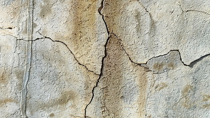  A crack on the concrete wall surface of a house in Los Angeles. Background image for design
