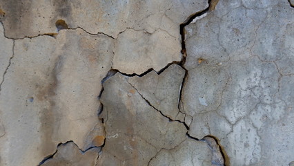  A crack on the concrete wall surface of a house in Los Angeles. Background image for design