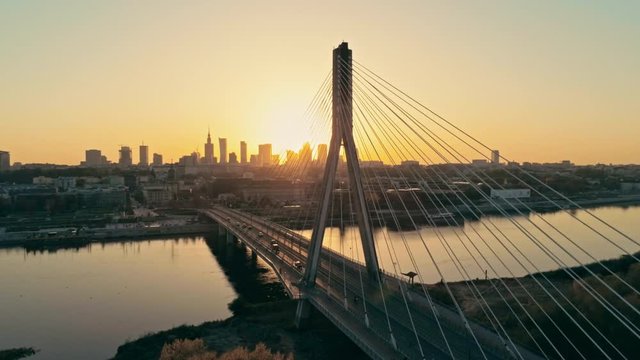 Establishing Aerial Panoramic Shot of Warsaw Cityscape, capital of Poland. Swietokrzyski Bridge and Downtown Skyline at Golden Sunset. 4K Panning Background Drone view Video with Copy Space