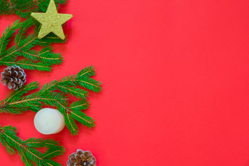 Christmas background on red canvas with green pine branches