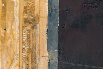 Aerial drone photography of an enormous sand pit construction site. 