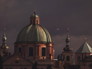 View of St. Francis of Assisi Church in Prague, under a dark sky.