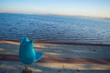 tulip shaped chair on lake sidewalk