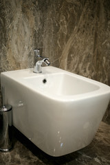 Toilet and bide bathroom isolated on black background.