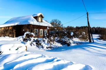 Fototapeta premium Old russian village with wooden houses. Early winter frost morning.