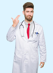 Young handsome doctor man wearing medical coat Shooting and killing oneself pointing hand and fingers to head, suicide gesture.