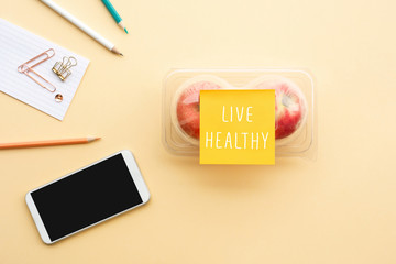 Live healthy concepts with text note and red apple in packaging on desk worktable background