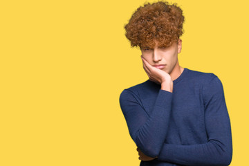 Young handsome man with afro hair thinking looking tired and bored with depression problems with crossed arms.