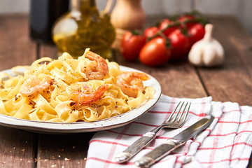 Tasty pasta with olive oil and fried shrimps