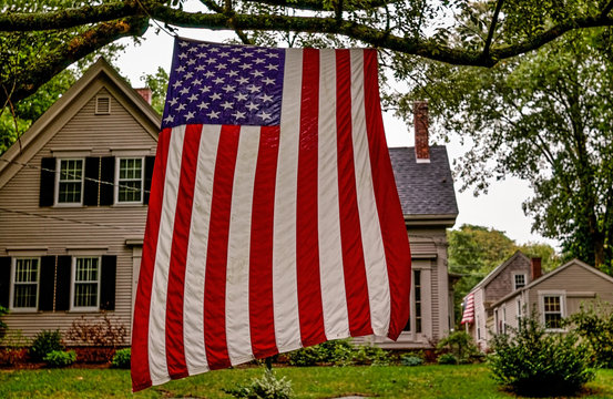Brewster, Massachucetts, USA - September 3, 2006- An American flag hangs vertically in a tree outside a typical Cape Cod house beside Highway MA-6A on Labor Day.jpg