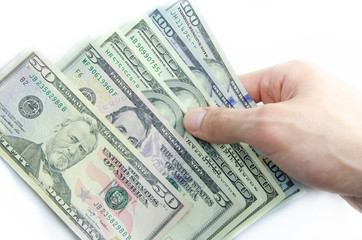 American dollars denominations of one hundred, fifty, five. Arranged in a chaotic manner, a short flight of stairs, a bill on a bill. Old sample and new notes. Dollars in hands are twisted into a tube