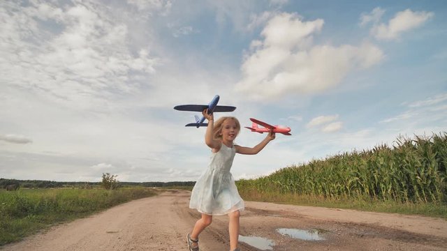 Little girl launches paralon toy airplanes.