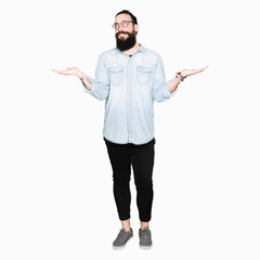 Young hipster man with long hair and beard wearing glasses Smiling showing both hands open palms, presenting and advertising comparison and balance