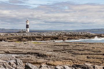 Lighthouse  and rocky beach in Inisheer island