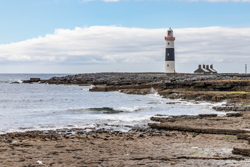 Lighthouse and rocky beach in Inisheer island
