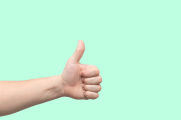 Closeup of male hand showing thumbs up sign